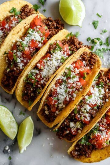 30 Minute Ground Beef Tacos filled with seasoned ground beef, fresh tomato salsa, cilantro, and crumbled cheese.