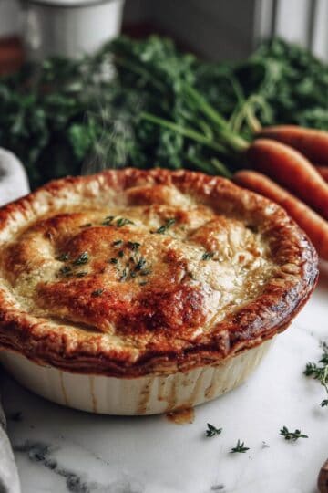 Golden, freshly baked Freezer Chicken Pot Pie Recipe, made with a flaky crust and garnished with thyme.