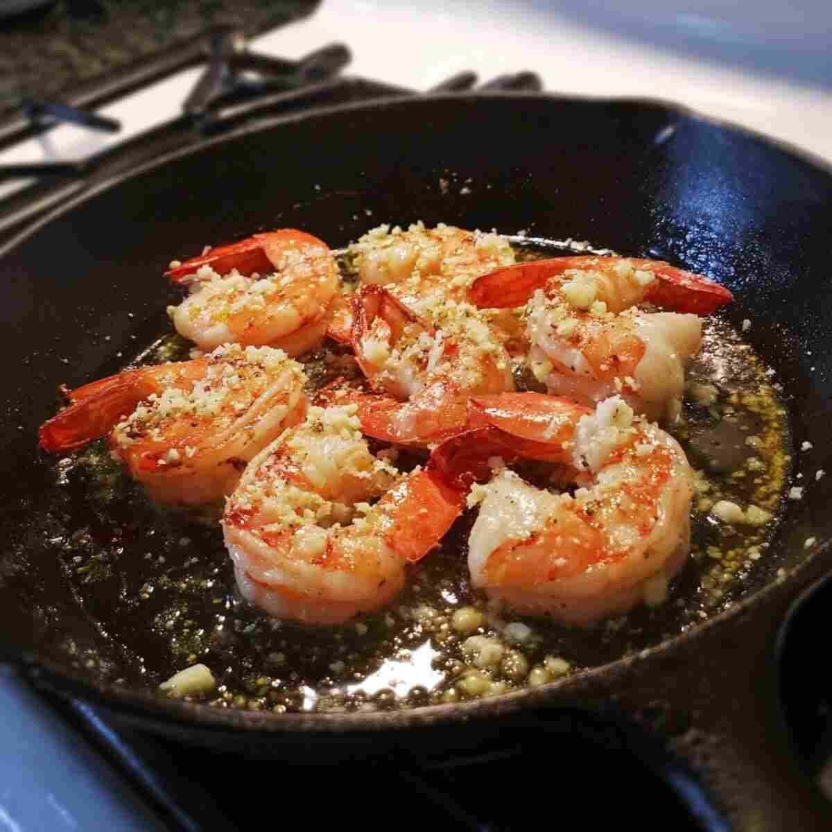 Garlicky sautéed shrimp cooking in a hot skillet; simple, aromatic, and ready in minutes for the perfect 30 Minute Garlic Shrimp dinner.