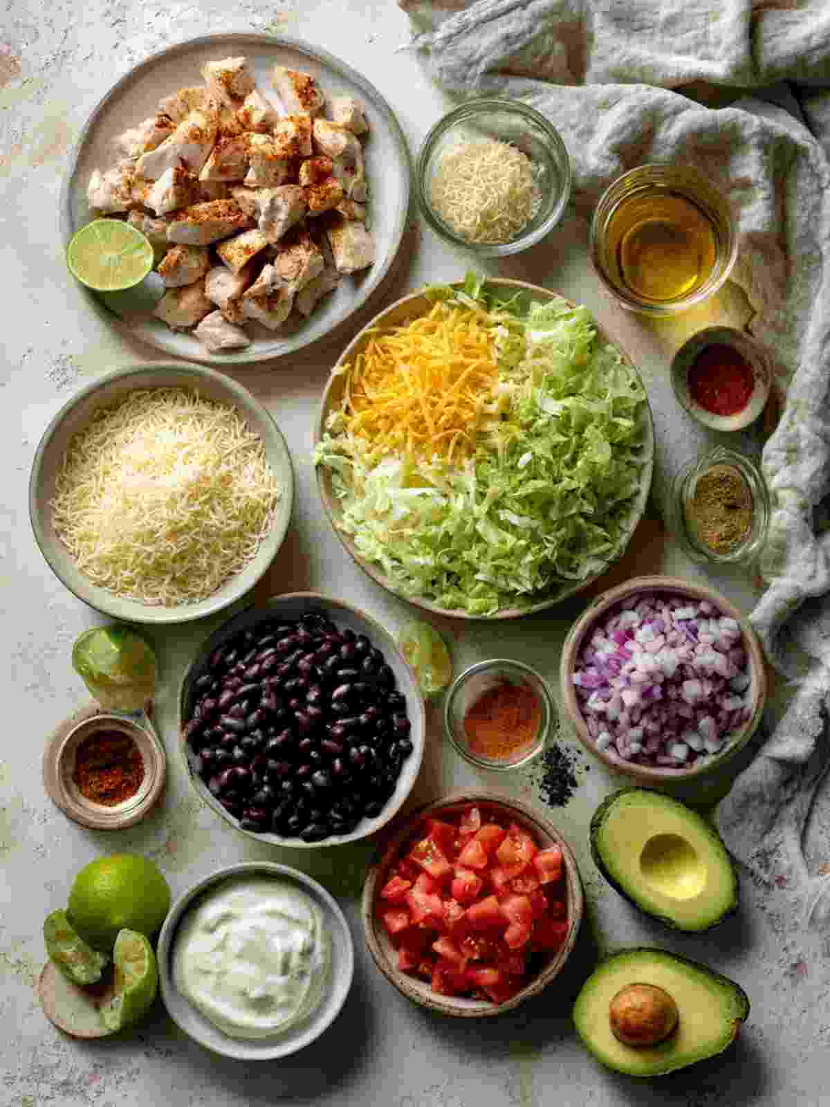Chicken taco bowl ingredients arranged on a kitchen surface