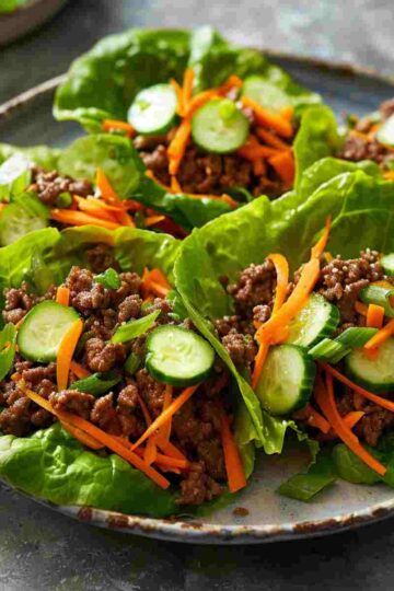 Ground beef lettuce wraps with fresh toppings and Asian-style sauce
