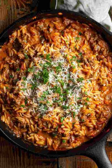 Ground beef orzo recipe in creamy tomato sauce served in a skillet