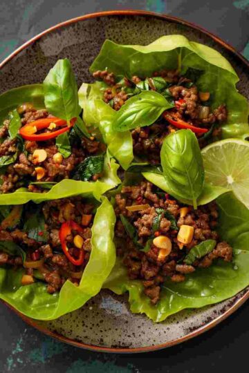 Thai basil beef rolls served in crisp lettuce leaves with savory ground beef and fresh Thai basil
